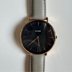 Light grey leather strap watch with black face and rose gold hardware
